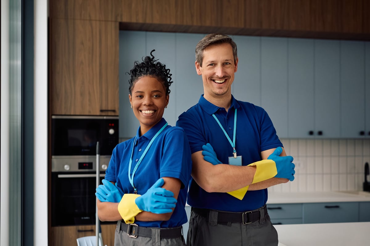 A team of professional cleaners standing together, ready for a commercial job
